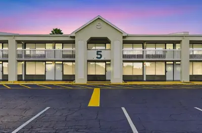a building with the number in a parking lot at Moana Adventure Suite Near Disney in Kissimmee