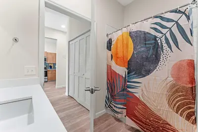 a room with a door with a painting on the wall at Riviere 2BR Apartment Pet Friendly Oasis Sleeps 6 Close to Epic Universe Pool & Gym in Orlando
