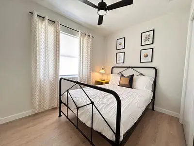 a bedroom with a bed and a ceiling fan at Cozy Modern 3BR Escape - Sanford in Sanford