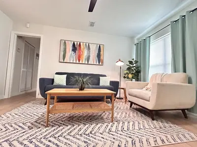 a living room with a couch and a table at Cozy Modern 3BR Escape - Sanford in Sanford