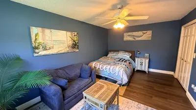 a living room with a couch and a bed at The little Manatee Apartment in Orlando