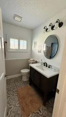 a bathroom with a sink and a toilet and a mirror at The little Manatee Apartment in Orlando