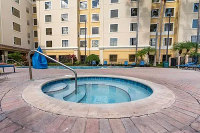 a small pool in a courtyard in front of a building at Cozy 1BR near Universal International Drive in Orlando
