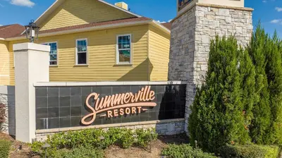 a yellow house with a sign for a summerville resort at Townhome 4Q em Summerville Resort – Orlando in Orlando