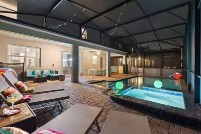 a large living room with a pool in a house at Bookmark Villa 8Q no Storey Lake c/ Piscina in Kissimmee