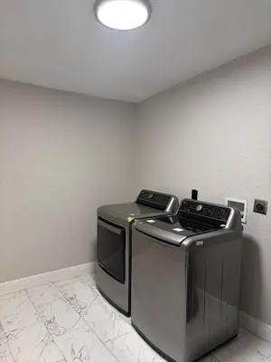 a washer and dryer in a corner of a room at Game Day Getaway-Downtown Orlando in Orlando