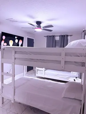 a white bunk bed in a bedroom with a ceiling at Game Day Getaway-Downtown Orlando in Orlando