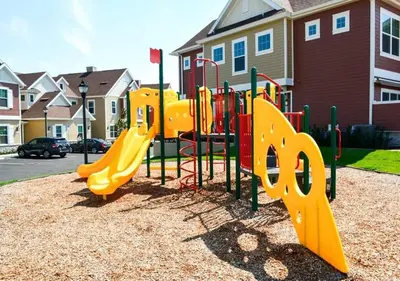 a playground with a yellow slide in a park at Townhome 4Q c/ Temática Disney in Orlando
