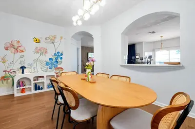 a dining room with a wooden table and chairs at Themed Villa with Private Pool, Game Room, Resort Amenities, BBQ in Orlando