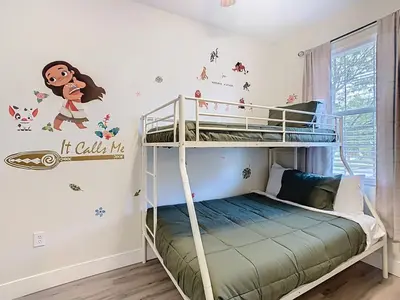 a bedroom with bunk beds with a monkey wall decal at 3BR Family-Friendly Town Home Near Disney in Orlando