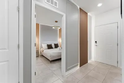 a bedroom with a bed and a door leading into a room at 207 Storey Lake 6 Guests 2 BDRS near clubhose in Kissimmee