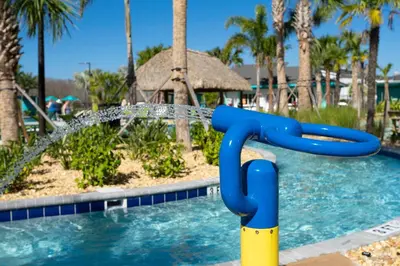 a water slide in a pool at a resort at South-Facing Pool 5BR Storey Lake Lazy River 2437 in Kissimmee