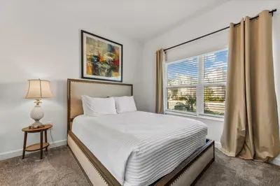 a bedroom with a bed and a window at South-Facing Pool 5BR Storey Lake Lazy River 2437 in Kissimmee