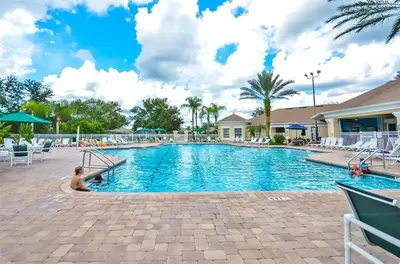 a swimming pool at a resort with a child sitting in it at Private Pool 3BR Resort Villa near Disney in Kissimmee