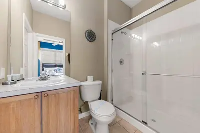 a bathroom with a toilet and a shower and a sink at Private Pool 3BR Resort Villa near Disney in Kissimmee