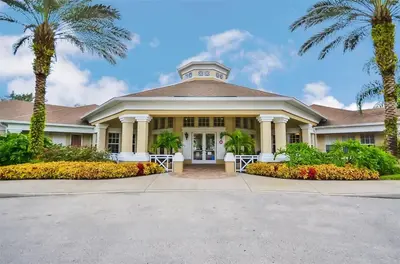 a large house with palm trees in front of it at Private Pool 3BR Resort Villa near Disney in Kissimmee