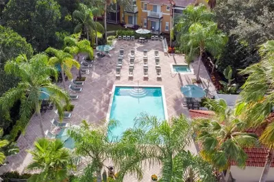 an aerial view of the pool at a resort with palm trees at 4BR Luxury Villa Private Pool & Slide Disney in Kissimmee