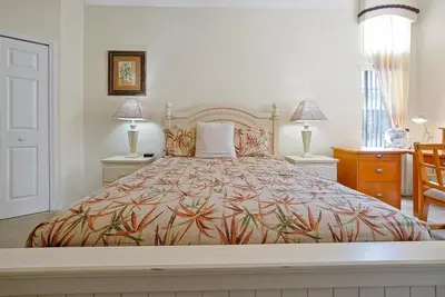 a large bed in a bedroom with two tables and two lamps at 4BR Luxury Villa Private Pool & Slide Disney in Kissimmee