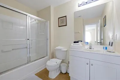 a bathroom with a shower and a toilet and a sink at 4BR Luxury Villa Private Pool & Slide Disney in Kissimmee