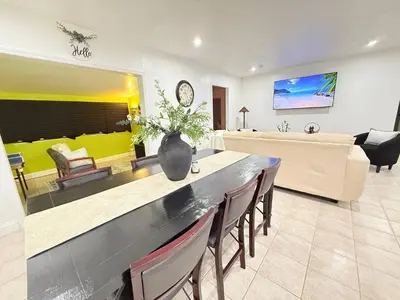 a living room with a table and a couch at Family Pool Home |Close to Disney/Universal/Epic in Kissimmee