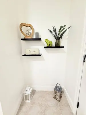 a hallway with two shelves on the wall with plants at Family Pool Home |Close to Disney/Universal/Epic in Kissimmee