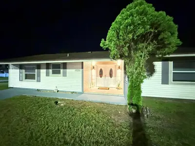 a house with a tree in front of it at Family Pool Home |Close to Disney/Universal/Epic in Kissimmee