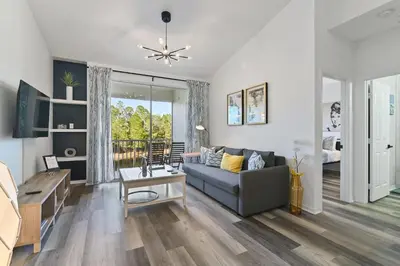 a living room with a couch and a table at Pause Discover something that nourishes your soul in Kissimmee
