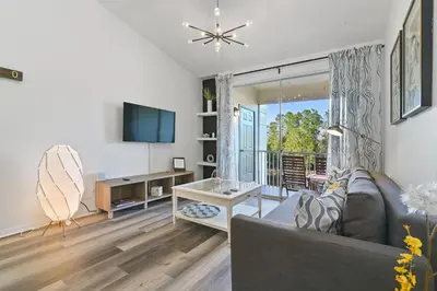a living room with a couch and a tv at Pause Discover something that nourishes your soul in Kissimmee