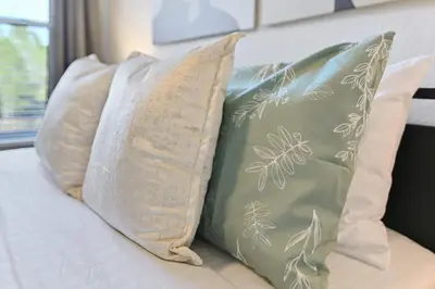 a group of pillows sitting on a bed at Pause Discover something that nourishes your soul in Kissimmee