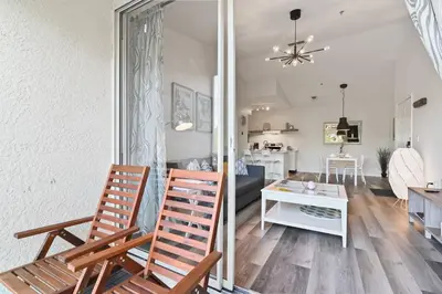 a living room with two chairs and a table at Pause Discover something that nourishes your soul in Kissimmee