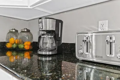 a counter top with a blender and fruit in a kitchen at Sunset every single day ReserveView 4BRElevator in Kissimmee