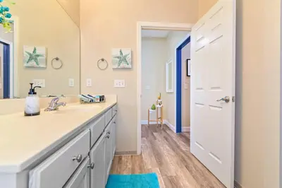a bathroom with a sink and a mirror at SPECTACULAR CONDO only 4 Miles to Disney! in Kissimmee
