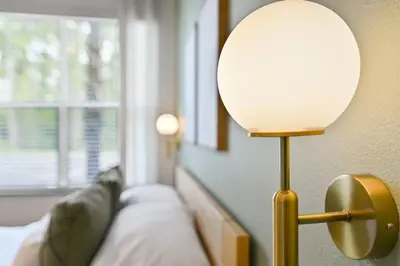 a lamp sitting next to a couch in a room at Discover paradise - NEW! Pool House Next to Disney in Orlando