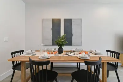 a wooden table with black chairs and a dining room at Oasis NEW Townhome Splash Pool Nature-Infused in Orlando