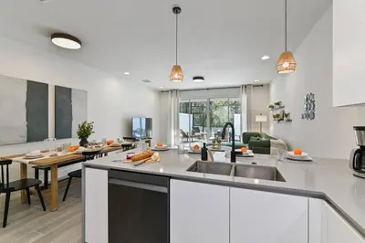 a kitchen with a sink and a counter top at Oasis NEW Townhome Splash Pool Nature-Infused in Orlando