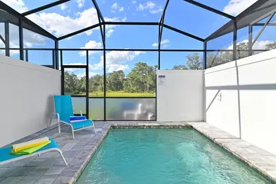 a swimming pool in a house with a glass ceiling at Happiness is a destination ! - NEW house with pool in Orlando