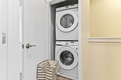 a washing machine and a washer and dryer in a room at Happiness is a destination ! - NEW house with pool in Orlando