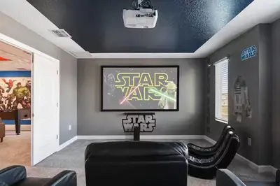a living room with a star wars painting on the wall at Casa 9Q no Storey Lake c/ Piscina Cinema e Games in Kissimmee
