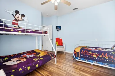 a bedroom with two bunk beds and a ceiling fan at Windsor Palms 3BR FUN Retreat, Pool, Near Disney in Kissimmee