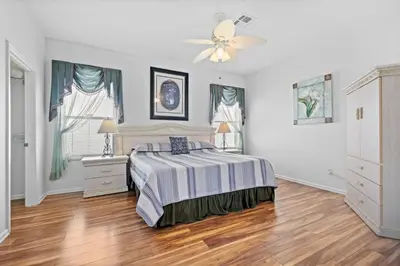 a bedroom with a bed and a ceiling fan at Windsor Palms 3BR FUN Retreat, Pool, Near Disney in Kissimmee
