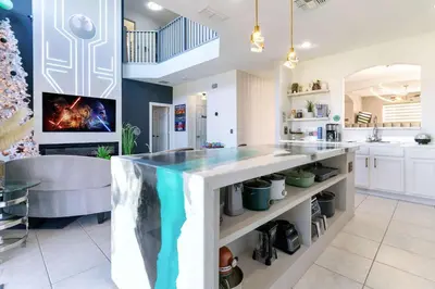 a kitchen with a large counter with a fish tank at New Modern STAR WARS Villa Only 3 Miles 2 Disney w VR's in Kissimmee
