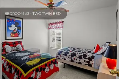 a bedroom with a bed and a ceiling fan at Cozy 3BR Family Home Minutes from Disney in Kissimmee