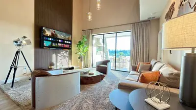 a living room with a couch and a tv at Brand New Home with 4 En-Suites, near Disney in Kissimmee