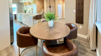 a dining room with a table and some brown chairs at Brand New Home with 4 En-Suites, near Disney in Kissimmee