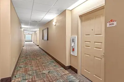 a hallway with a door and a tile floor at Apto c/ Vista Piscina – Perto da Disney 1Q in Orlando