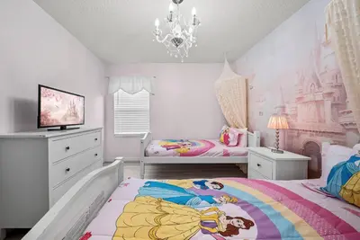 a bedroom with two beds and a chandelier at Amazing 08 BdrmsSleeps 14Pool in Kissimmee