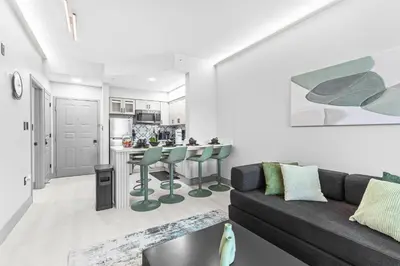 a living room with a couch and a kitchen at 1 bedroom apartment near Disney and Universal in Orlando