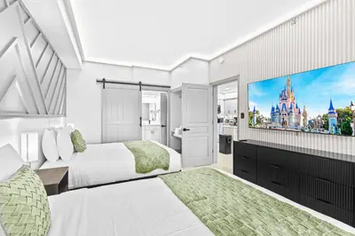 a bedroom with two beds and a flat screen tv at 1 bedroom apartment near Disney and Universal in Orlando