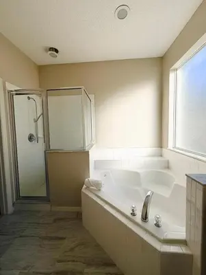 a large bathroom with a tub and a shower at 7 Bd/ 5.5 Ba- Terra Verde Resort -Near Disney in Kissimmee