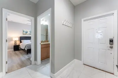 a bedroom with a bed and a door with a mirror at Four Bedroom Private Pool Townhome, near Disney in Kissimmee